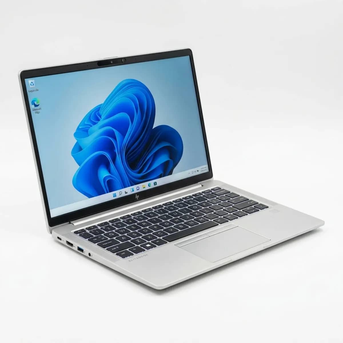 A stack of HP EliteBook laptops prepared for delivery